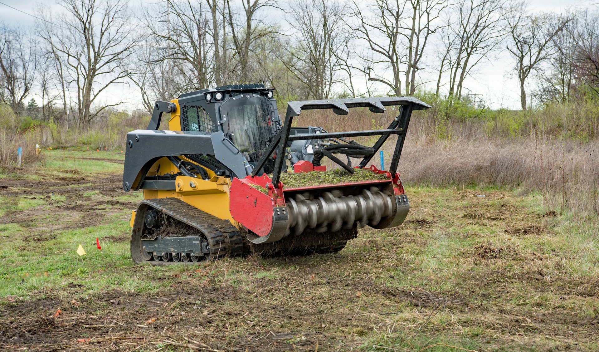 Forestry mulcher clearing field for new development