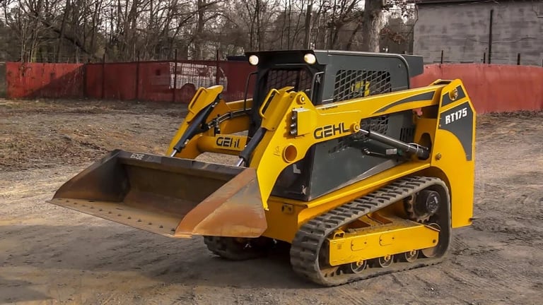 Yellow Gehl compact track loader with bucket attachment on construction site